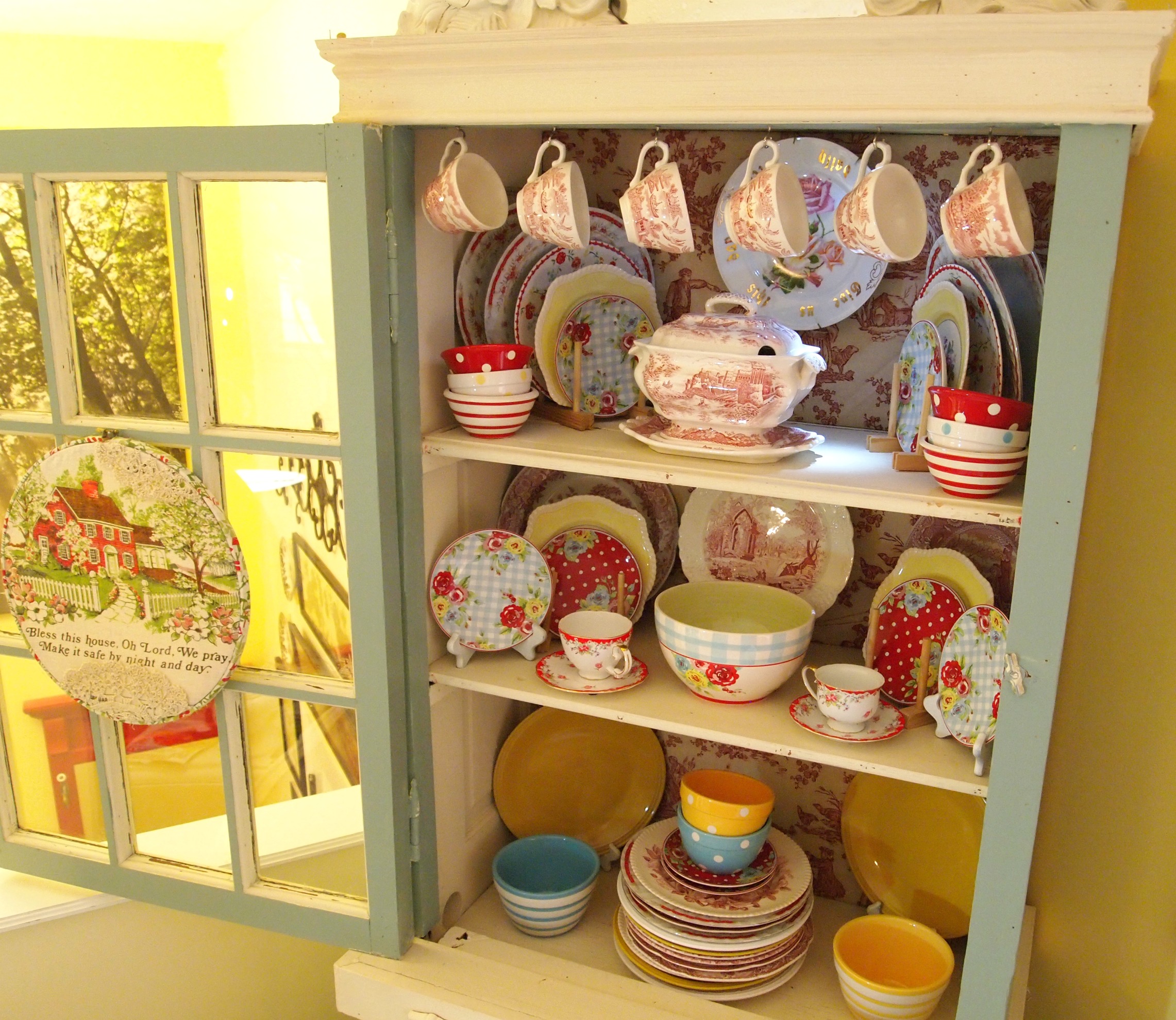 How do you arrange the dishes in a china cabinet?