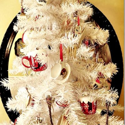 Cute Christmas tree for a dining room or kitchen, Decorated with teacups and check out the silverware as ornaments!