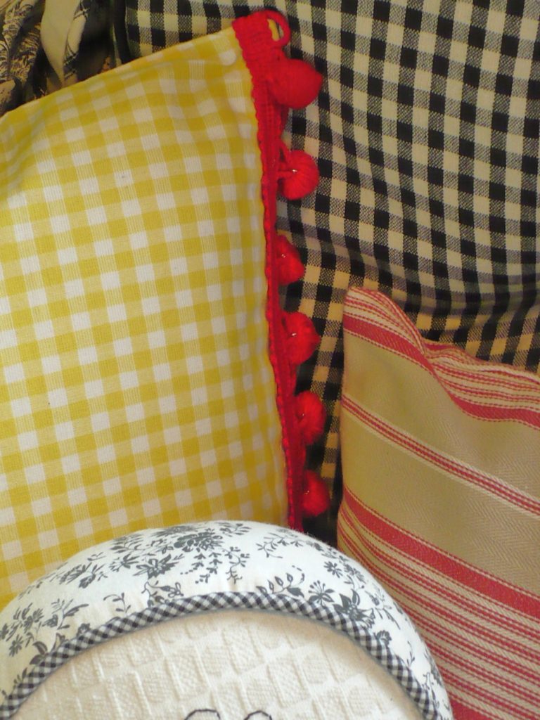 yellow gingham pillow with red trim