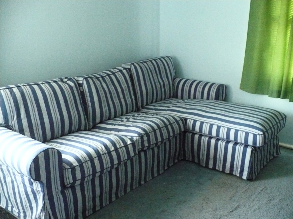 IKEA sectional sofa with blue slipcover