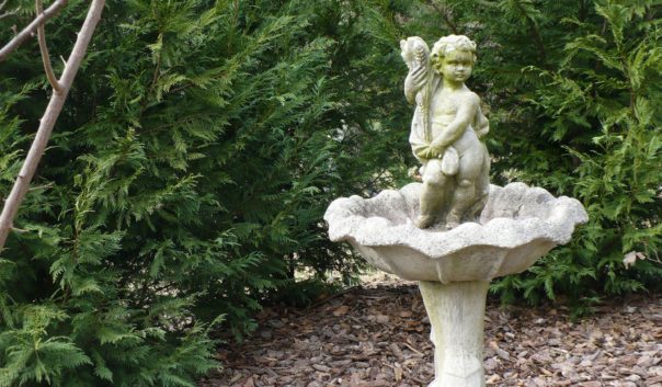 cherub statue in birdbath