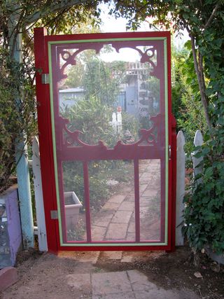 red screen door in the garden