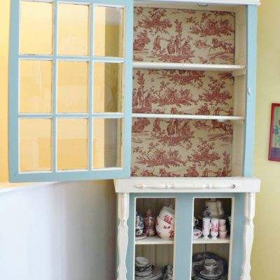 cabinet with back lined in red toile