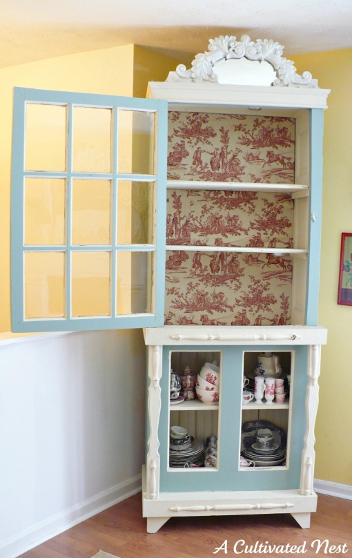 cabinet with back lined in red toile