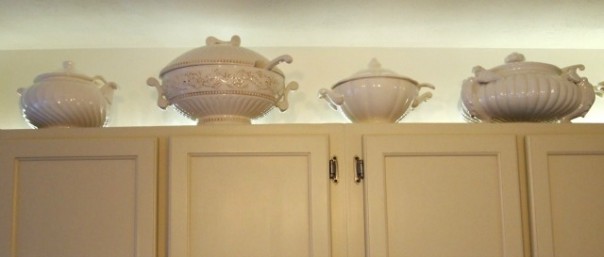 soup tureens above cabinets