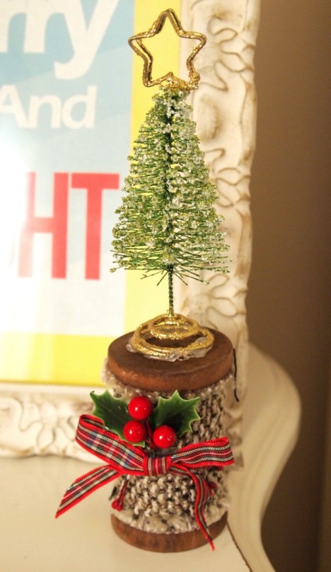 wooden spool with tree on top