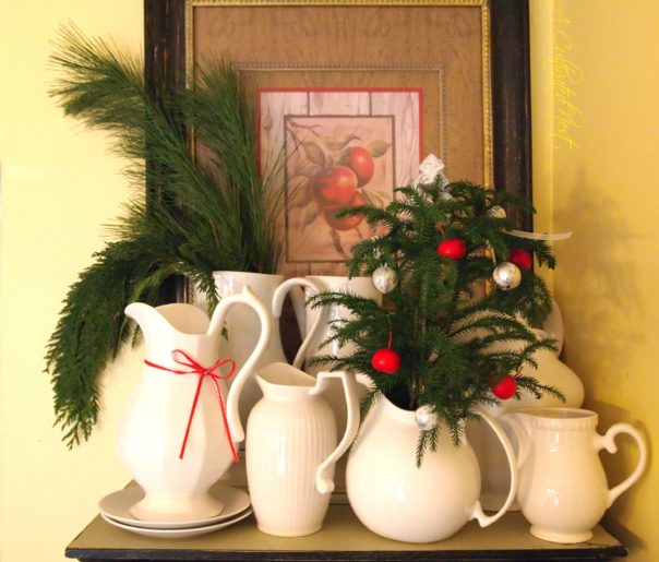 white pitchers with Christmas greenery