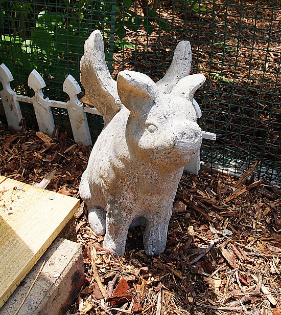 concrete pig statue with wings