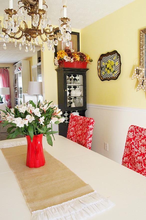 burlap runner and flowers in a red pitcher