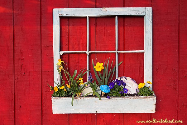 Whimsical spring window box with vintage plates