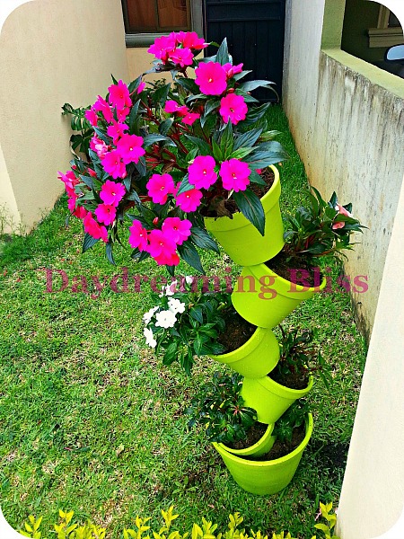 15 Amazing Flower Towers or Tipsy Pot Planters Ideas- These DIY flower towers and tipsy pot planters are stunning ways to add vertical interest to your garden, porch, or front entry! | #tipsyPot #flowerTower #DIY #gardening #ACultivatedNest