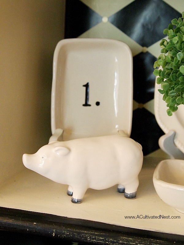 white ceramic pig in a china cabinet