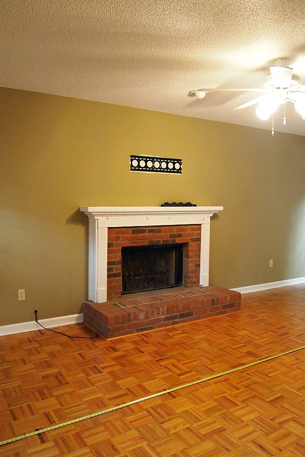 brick fireplace with white mantel
