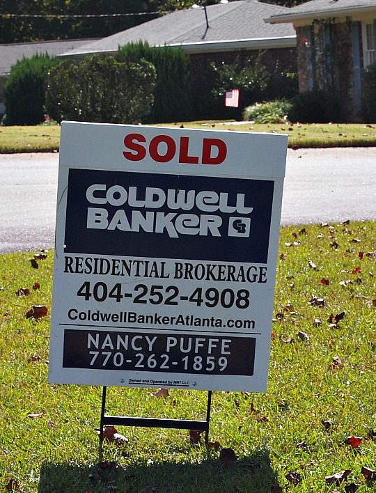 real estate sign that says sold