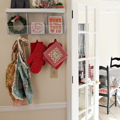 Cute kitchen shelf with hooks and cubbies provides needed storage and display space in a small kitchen