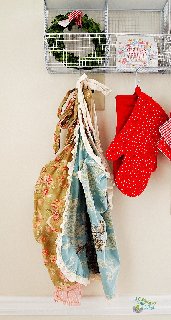 A pretty way to provide some extra storage for potholder and aprons.