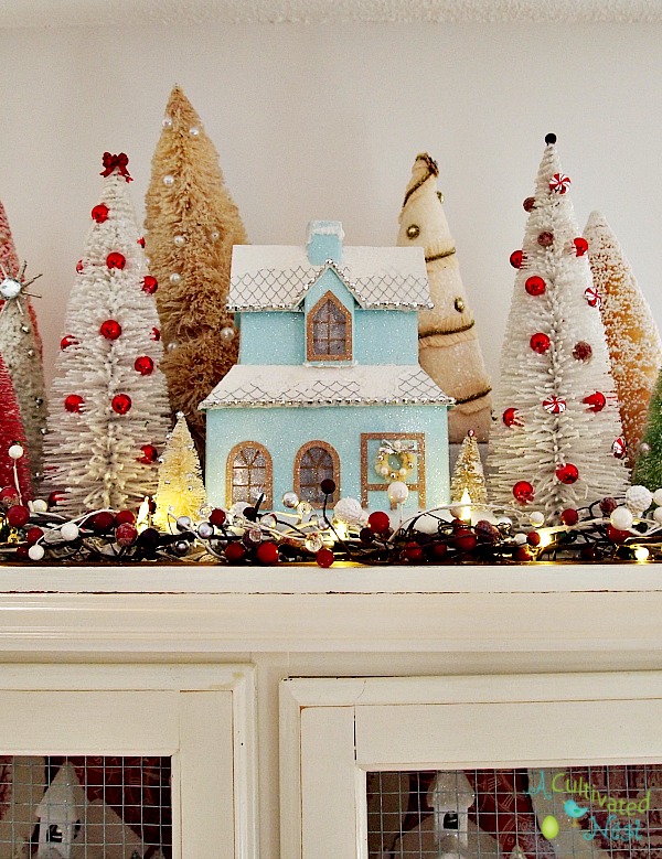 Pretty glittery Christmas china cabinet decorations.