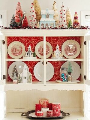 Christmas china cabinet decorating idea. Bottle brush trees, glitter houses, red and aqua color scheme