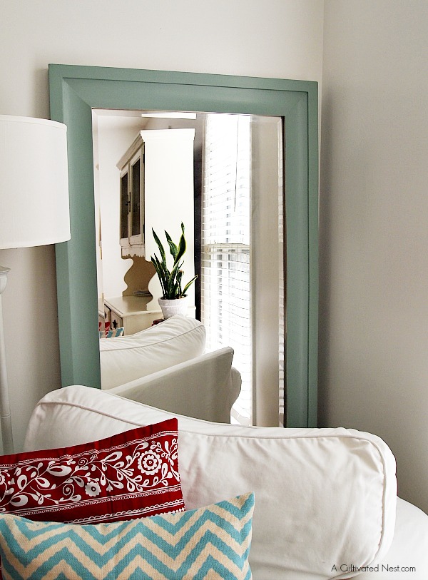 large wall mirror behind white Ektorp chair