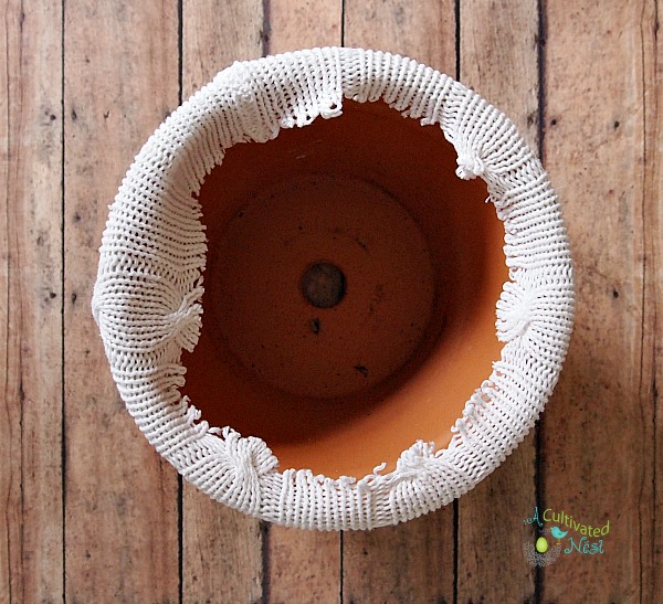 recycle an old sweater and cover a flower pot