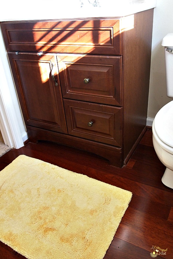 vanity and floors in yellow bathroom