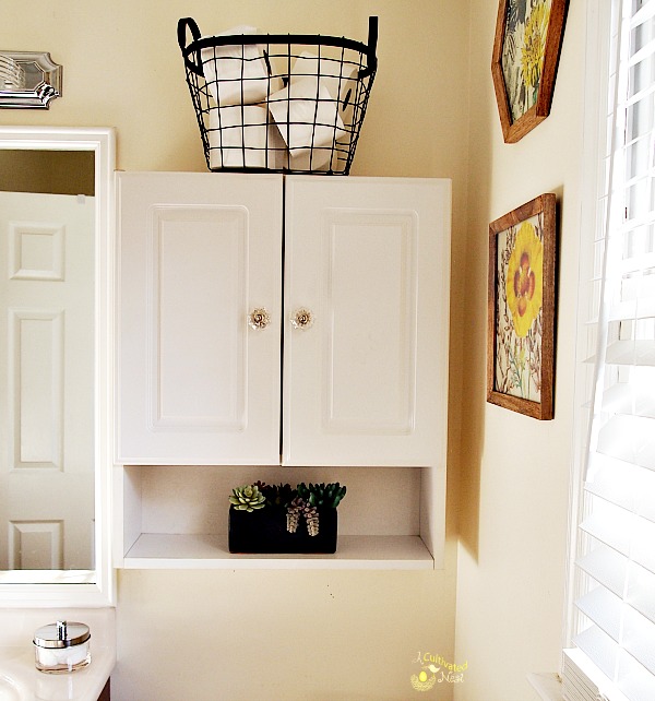 Use a wire basket to hold extra bathroom supplies like TP 