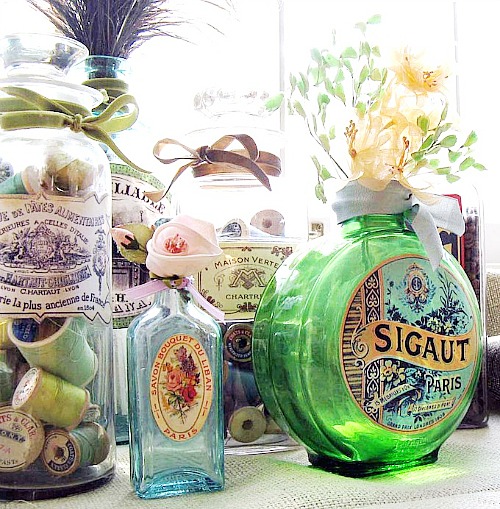 https://acultivatednest.com/wp-content/uploads/2015/04/DIY-mod-podge-bottles-with-vintage-labels.jpg