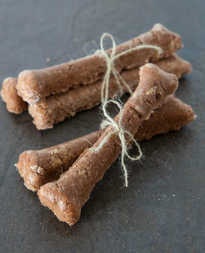 18 Easy Dog Treat Recipes to Make at Home- An easy way to save money on your pet expenses and ensure your dog eats healthy is by making these easy homemade dog treat recipes! | #dogTreats #homemadeDogTreats #dogTreatRecipes #pets #ACultivatedNest