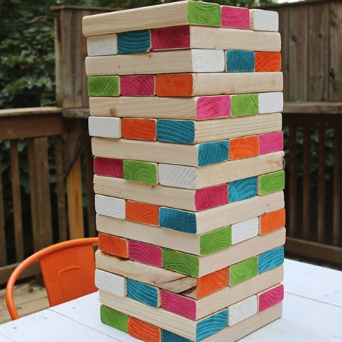 Giant Backyard Jenga- Here are 10 inexpensive summer outdoor activities that will keep the kids or grandkids occupied all summer long! Definitely give these a try this summer! | #kidsActivities #frugalLiving #summerActivities #summerKidsActivities #ACultivatedNest