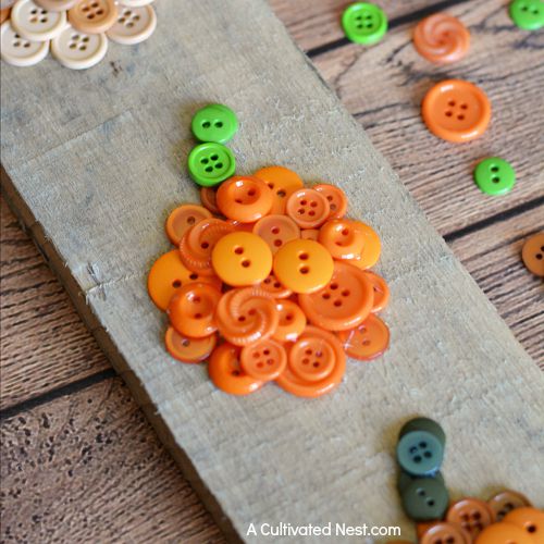 Fall DIY Pumpkin Button Wall Art- It can be easy to make cute DIY fall decor for your home! If you're looking for a cute fall decor project, you have to try this easy ombre pumpkin button craft! | #DIY #craft #fall #pumpkins #decor #buttons #buttonCraft #wallArt #autumn #ACultivatedNest