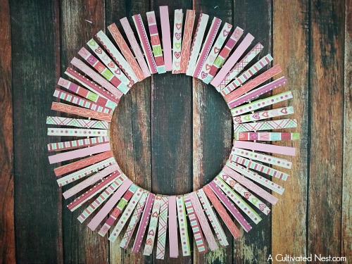 DIY Valentine's Day Clothespin Wreath- Want to make a different kind of Valentine's wreath this year? Then you have to make this adorable DIY Valentine's Day clothespin wreath! Use differently themed scrapbook paper and you can make a fun wreath for any season! | scrapbook paper scraps, love, hearts, frugal decor, #wreath #ValentinesDay #DIY #craft