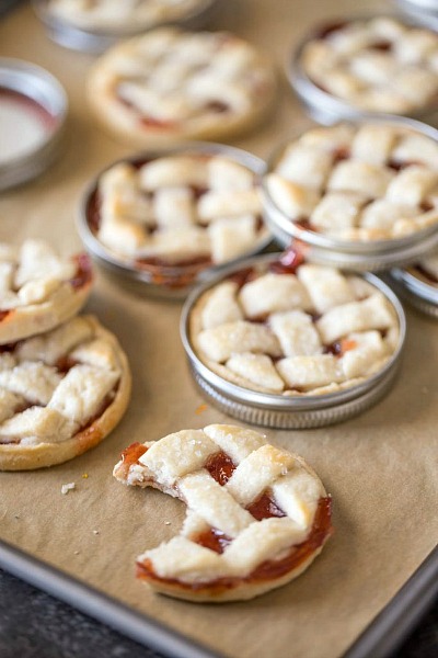 Mini Mason Jar Lid Strawberry Pies- If you've never tried making Mason jar lid desserts, then you're missing out! They're delicious, and the perfect size for party treats!