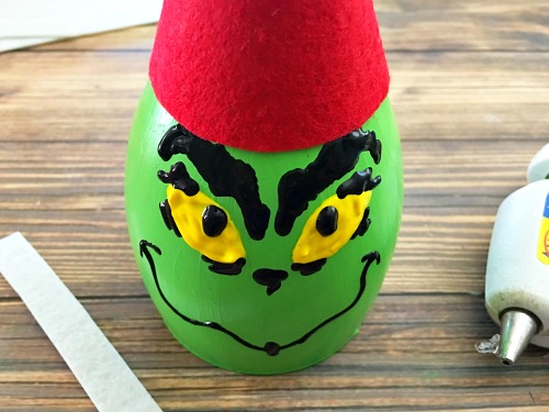 This DIY Grinch wine glass candle holder is a fun, easy and frugal holiday craft! It would also make a great holiday kids activity!