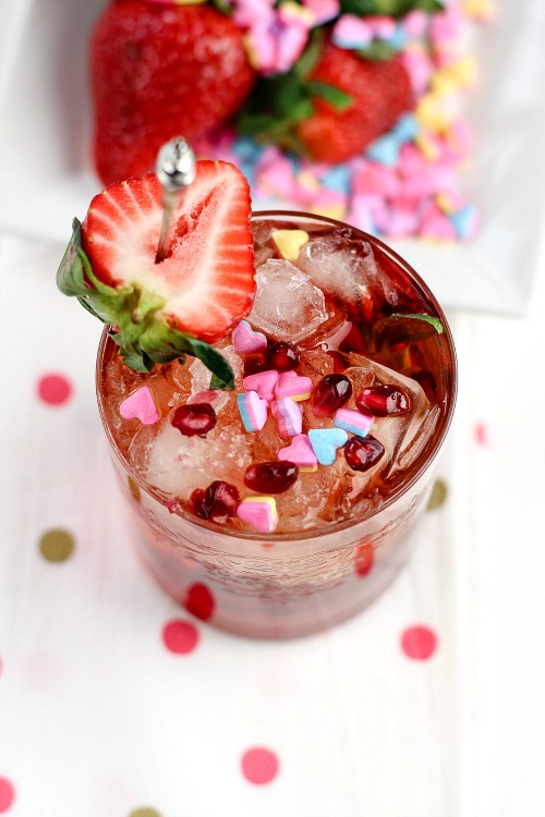 Pomegranate and Strawberry Cocktail- This homemade pomegranate and strawberry cocktail is quick to make and tastes delicious! It'd make a lovely drink treat for Valentine's Day, or any day! | alcoholic drink, alcohol, homemade drinks, beverage, fresh fruit, strawberries, hearts, Valentine's Day drink