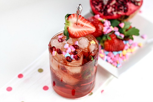 Pomegranate and Strawberry Cocktail- This homemade pomegranate and strawberry cocktail is quick to make and tastes delicious! It'd make a lovely drink treat for Valentine's Day, or any day! | alcoholic drink, alcohol, homemade drinks, beverage, fresh fruit, strawberries, hearts, Valentine's Day drink