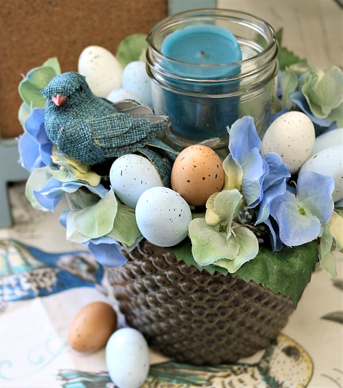DIY Spring Mason Jar Candle Arrangement- Make this pretty DIY spring Mason jar candle arrangement for your table or another featured spot in your home to easily update your decor! | DIY project, craft, spring decor, bird, eggs, Easter, blue, centerpiece