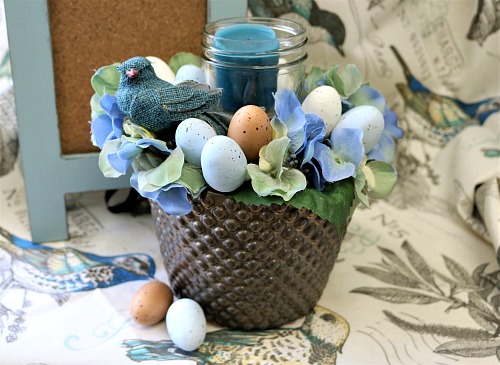 DIY Spring Mason Jar Candle Arrangement- Make this pretty DIY spring Mason jar candle arrangement for your table or another featured spot in your home to easily update your decor! | DIY project, craft, spring decor, bird, eggs, Easter, blue, centerpiece