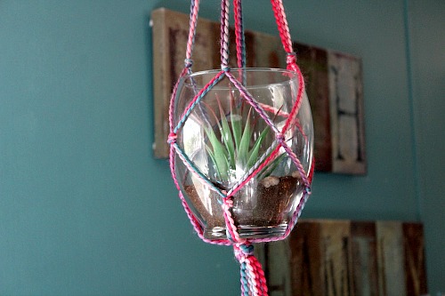 Yarn Macrame Plant Hanger- It's actually not difficult to make your own DIY yarn macrame plant hanger. The result is beautiful, and makes a great homemade gift! | DIY gift idea, macrame decor, plant pot holder, indoor gardening, garden, craft, macrame tutorial, macrame knots, colorful, bright, spring, summer, succulent pot holder, how to do macrame, how to make macrame