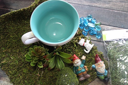 Gnome Tea Cup Fairy Garden- Need a cute decoration for your table or desk? Why not make this adorable DIY gnome tea cup fairy garden! It's easy (and inexpensive)! | DIY decor, gnome garden, cute fairy garden, faux succulents, dollar store, craft, DIY gift idea, homemade gift idea