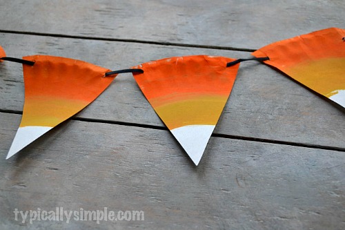 DIY Halloween Bunting- These DIY Halloween decorations are light on fright, heavy on fun, and easy on the budget! Check out these 15 homemade Halloween decor ideas! | Halloween wreaths, DIY Halloween candles, Mason jar craft, Halloween garland, bottle upcycle, October DIY decor