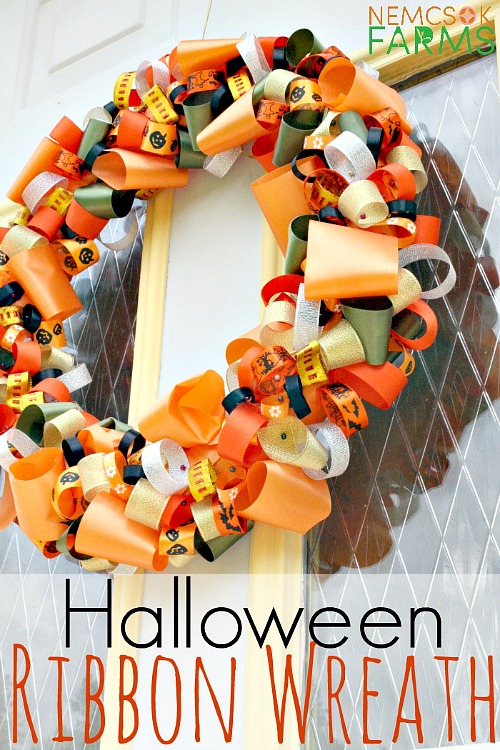 Halloween Wreath DIY- These DIY Halloween decorations are light on fright, heavy on fun, and easy on the budget! Check out these 15 homemade Halloween decor ideas! | Halloween wreaths, DIY Halloween candles, Mason jar craft, Halloween garland, bottle upcycle, October DIY decor
