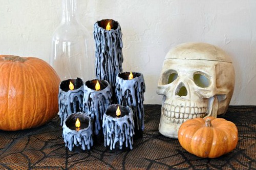 DIY Halloween Candles- These DIY Halloween decorations are light on fright, heavy on fun, and easy on the budget! Check out these 15 homemade Halloween decor ideas! | Halloween wreaths, DIY Halloween candles, Mason jar craft, Halloween garland, bottle upcycle, October DIY decor