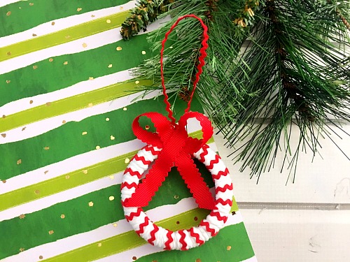 Candy Cane Mason Jar Lid Ornament- Make your Christmas tree even prettier this year with a DIY ornament! Check out my tutorial on how to make a cute candy cane Mason jar lid ornament! #Christmas #diy #craft #ornament