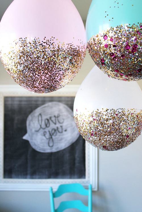 DIY New Year's Eve Glitter Dipped Balloons- You can have a fun and glamorous New Year's Eve without spending a lot! Check out these 15 DIY New Year’s Eve décor ideas for inspiration! #DIY #NewYearsEve #decor #craft #ACultivatedNest