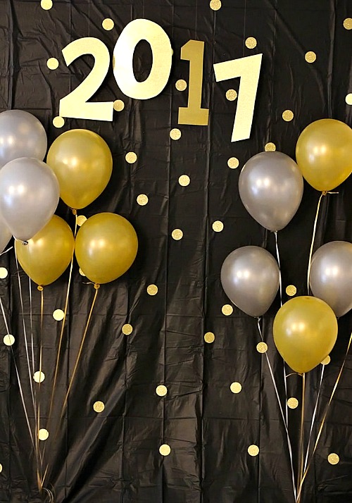 DIY New Year's Photo Backdrop- You can have a fun and glamorous New Year's Eve without spending a lot! Check out these 15 DIY New Year’s Eve décor ideas for inspiration! #DIY #NewYearsEve #decor #craft #ACultivatedNest