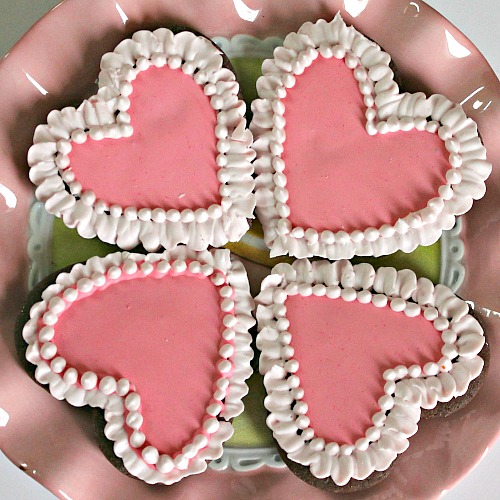 Chocolate Heart Cookies with Raspberry Liqueur Icing- Show your love this Valentine's Day by giving your sweetheart a plate of crunchy chocolate heart cookies with raspberry liqueur icing! Instructions are included for how to make the icing non-alcoholic and kid-friendly. | baking, homemade, dessert, fancy icing, love, alcohol, #cookies #ValentinesDay #heart #recipe