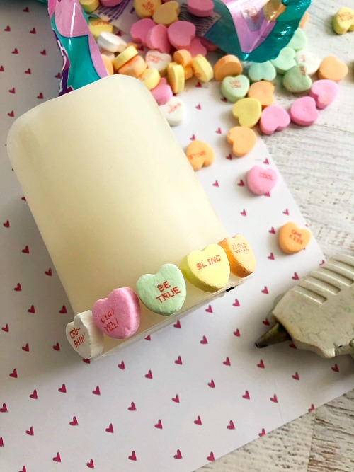 DIY Conversation Heart Valentine's Day Candle- Want a cute, yet inexpensive piece of Valentine's decor? Then you have to make this DIY conversation heart Valentine's Day candle! It's very easy to put together, and can be customized in many fun ways! | Valentine's craft, love, conversation heart candy, sweethearts, craft using food, hearts, #ValentinesDay #candle #diy #Valentines