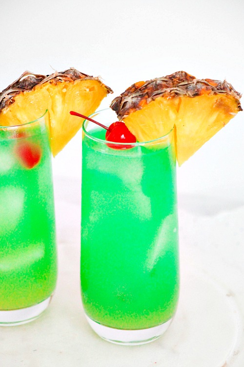 Blue Hawaii Mocktail Drink Recipe- Looking for the perfect drink to serve at a summer get-together? You have to try this Blue Hawaii mocktail! It's just as refreshing and delicious as the traditional version, but is alcohol-free and kid-friendly! | easy drink recipes for kids, #drink #recipe #mocktail #nonAlcholic #alcoholFree #summerDrink