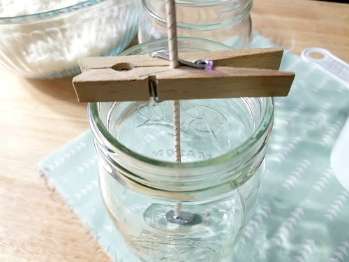 DIY Mason Jar Citronella Lavender Candle- Clothespin holding wick. | homemade citronella candles, #DIY #candle #citronella #MasonJar #craft #allNatural #bugRepellent #mosquitoes #essentialOils