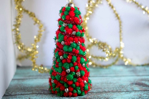 DIY Dollar Store Christmas Tree Centerpiece- Add pretty (and inexpensive) decor to your Christmas table or mantel with this DIY dollar store Christmas tree centerpiece! | Christmas craft, holiday DIY, pom pom Christmas tree, dollar store craft, #Christmas #DIY #ACultivatedNest